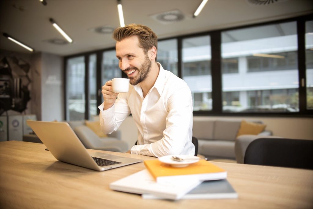 Drinking Coffee over Laptop